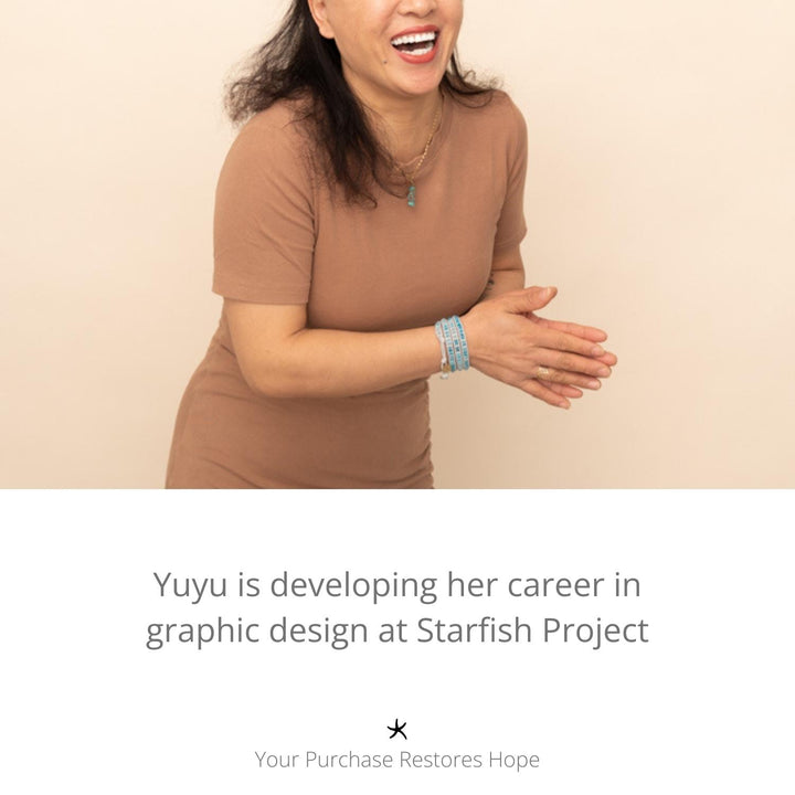 Photo of woman clapping and wearing high quality gold jewellery, golds, women's artisan jewellery, jewellery company, freedom organization