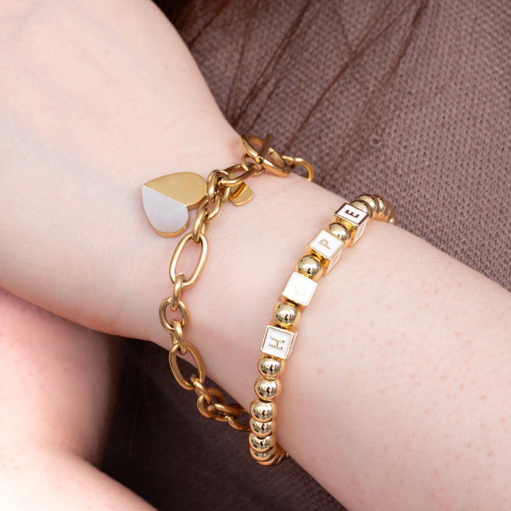 A woman wearing a gold bracelet set, freedom business, great Christmas gift ideas for women