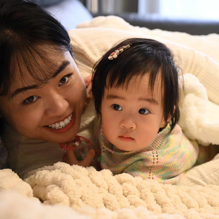 A woman and her baby in a comfortable white coloured blanket, soft baby blankets for women, home shopping