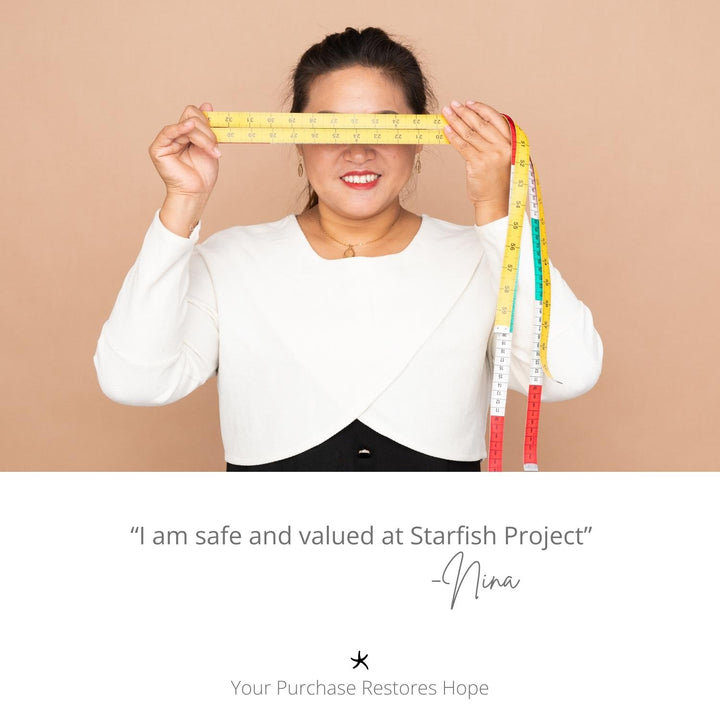 Picture of woman wearing Starfish Project pieces, handcrafted jewellery, symbol of hope, women's artisan jewellery business