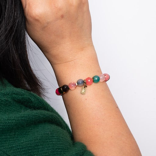 A woman wearing multicoloured beaded bracelet, handmade bracelets for women, freedom business jewellery, jewellery fair trade