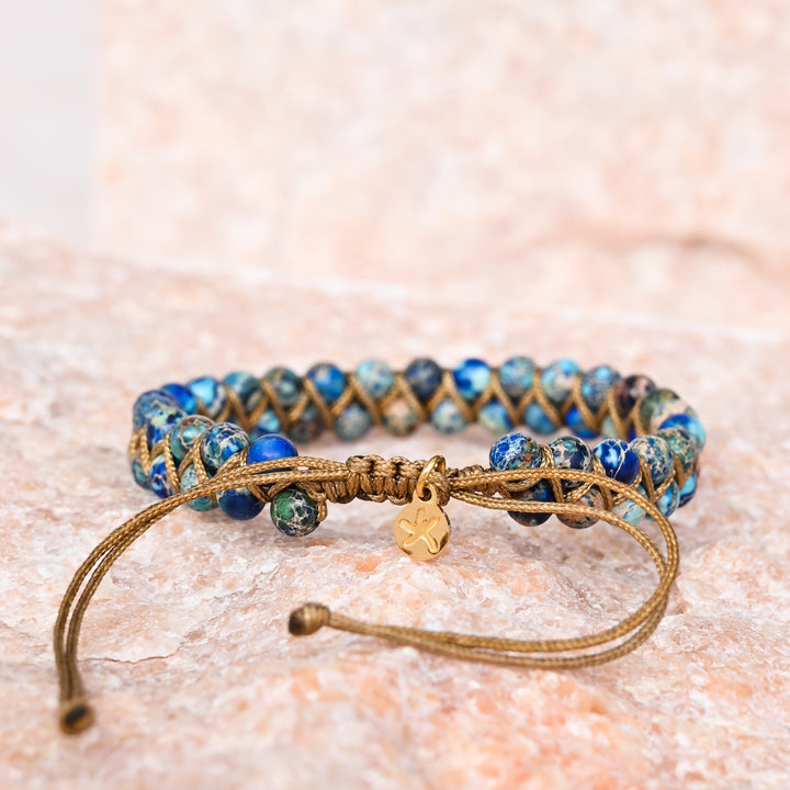 Beaded bracelet with shades of blue and accents of gold, starfish logo, meaning of starfish, jewellery website