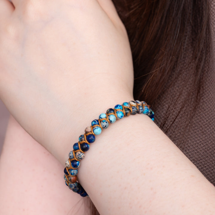 A woman wearing shaded blue bracelet, bracelet with blue beads, women's jewellery company, beautiful xmas gifts